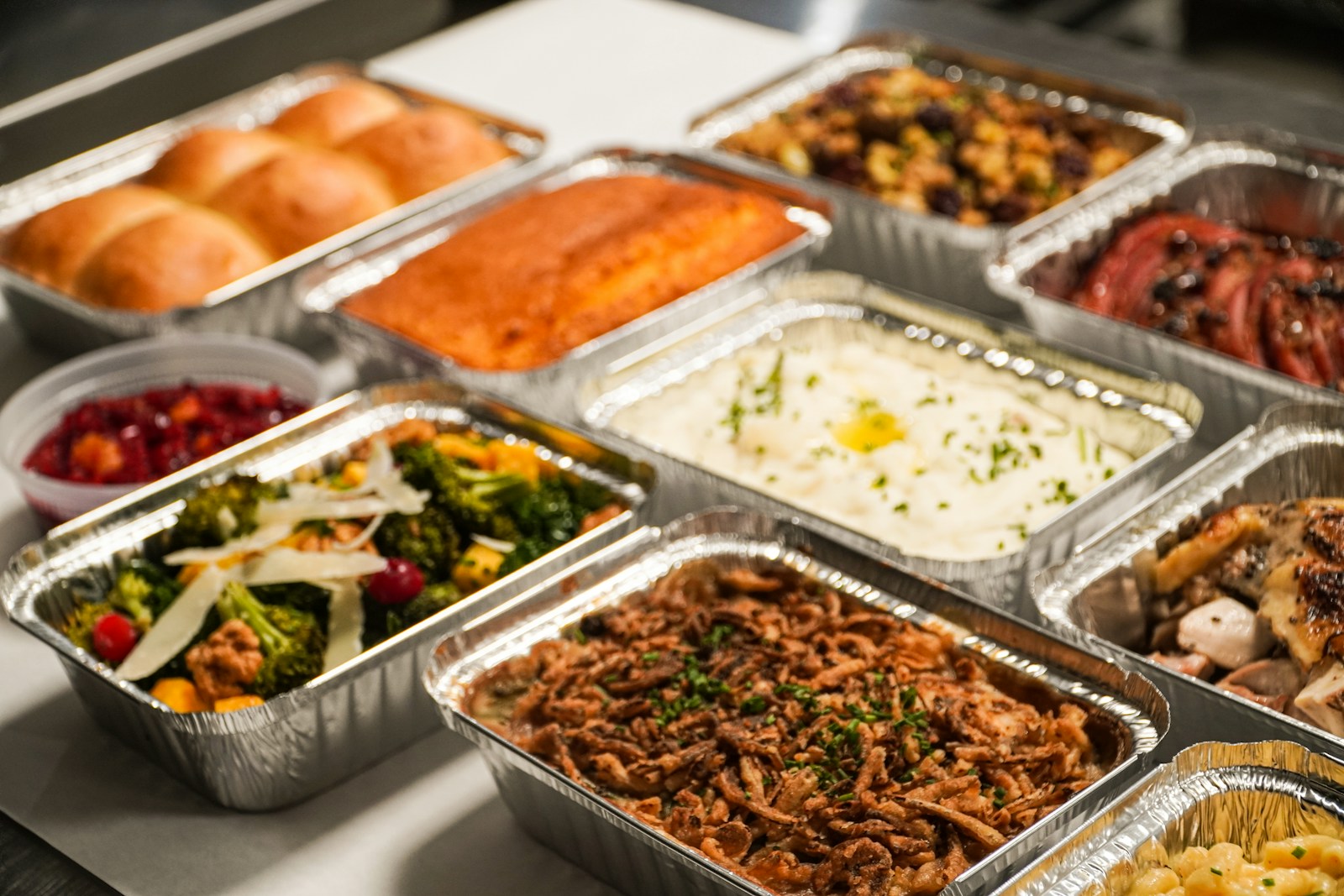 a table topped with lots of trays of food